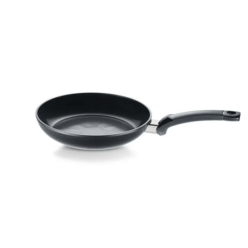 Fissler Ceratal® Classic Bratpfanne, Orbitschwarz, mit Keramikbeschichtung und geschwungenem Stiel, hier schräg auf weiß, PFAS/PTFE-frei.